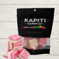 pink and white candy with packaging, Kapiti Candy co on a wooden surface