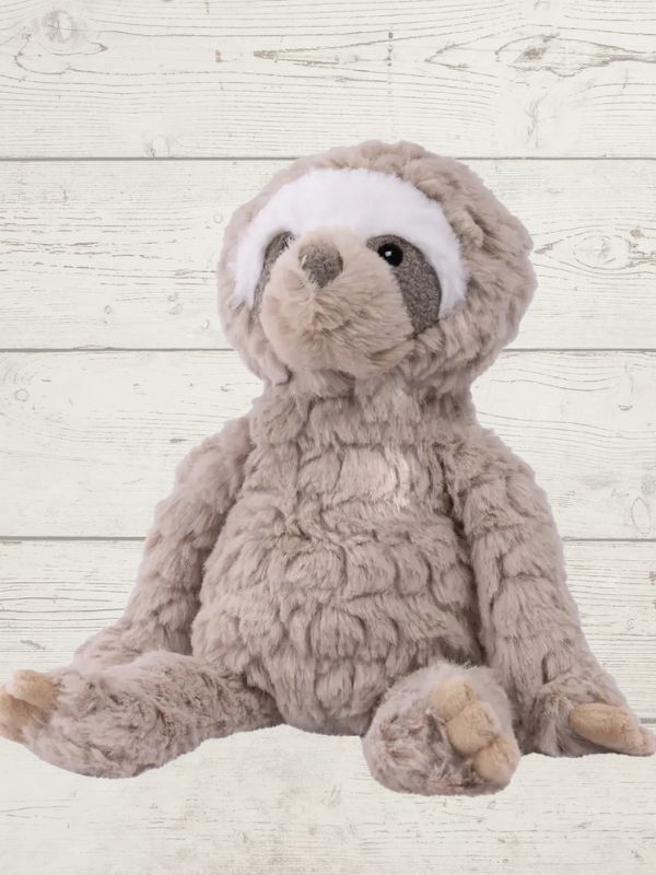 A plush toy resembling a sloth with brown and white fur, featuring embroidered eyes and a soft texture.