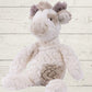 A plush toy resembling a giraffe with white fur, featuring embroidered eyes and a soft texture.