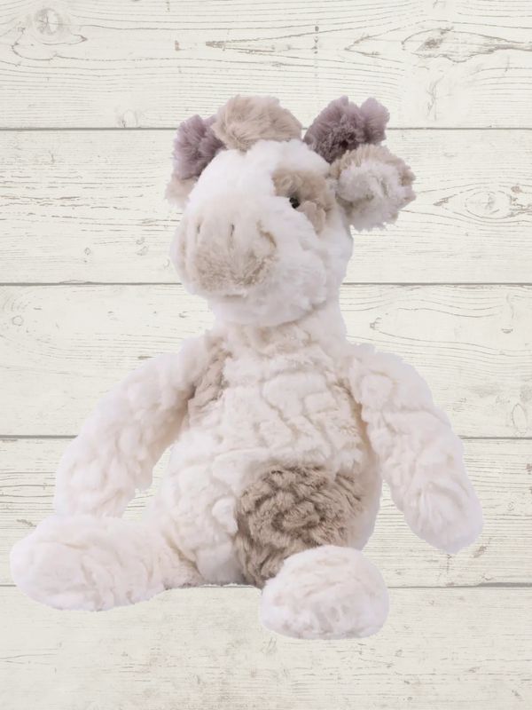 A plush toy resembling a giraffe with white fur, featuring embroidered eyes and a soft texture.