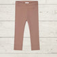 a pair of childrens leggings on a wooden surface
