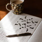crossword book with a coffee cup and pen on a table