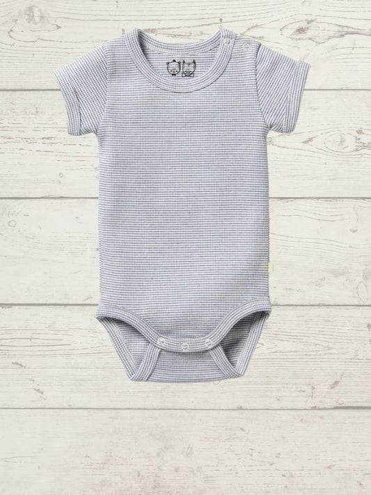 A gray short-sleeve rib bodysuit for babies, with a round neckline and side snap opening, displayed on a wooden background.