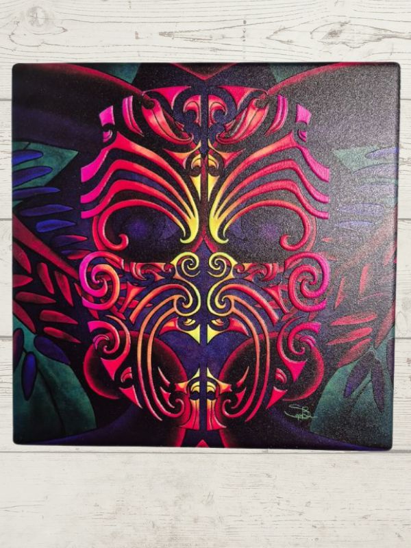 A ceramic tile featuring a colorful Moko (Maori) art design.