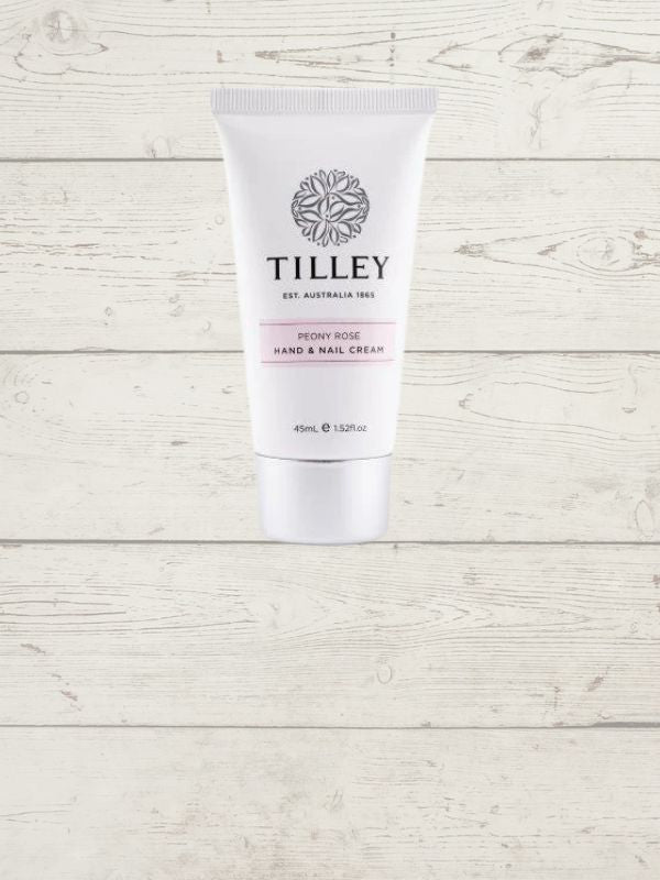 A tube of Tilley hand and nail cream against a white wooden background.