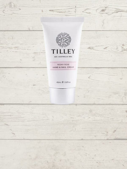 A tube of Tilley hand and nail cream against a white wooden background.