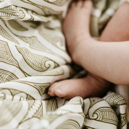 Close-up of a baby's foot on patterned fabric