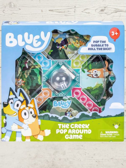 bluey game in a blue box with bluey and bandit on the box on a wooden backeground