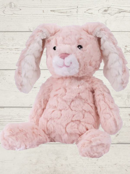 Two soft toy bunnies with beige and white coloring, sitting on a wooden surface. One bunny is plush and the other is a stuffed toy, both with embroidered eyes and a textured surface.