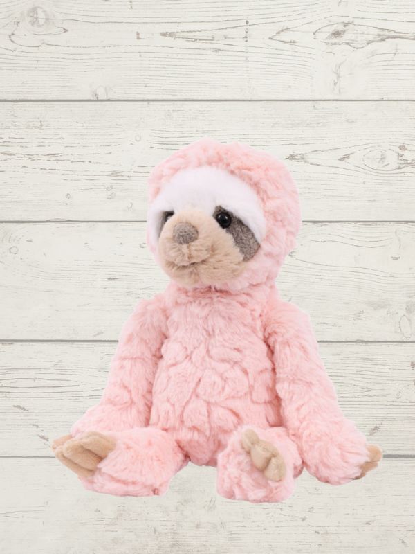 Pink sloth on a light wooden background