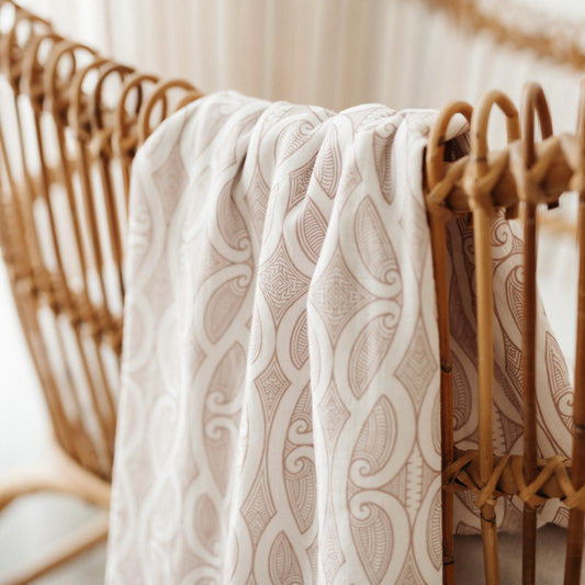 Patterned fabric draped over a wicker chair