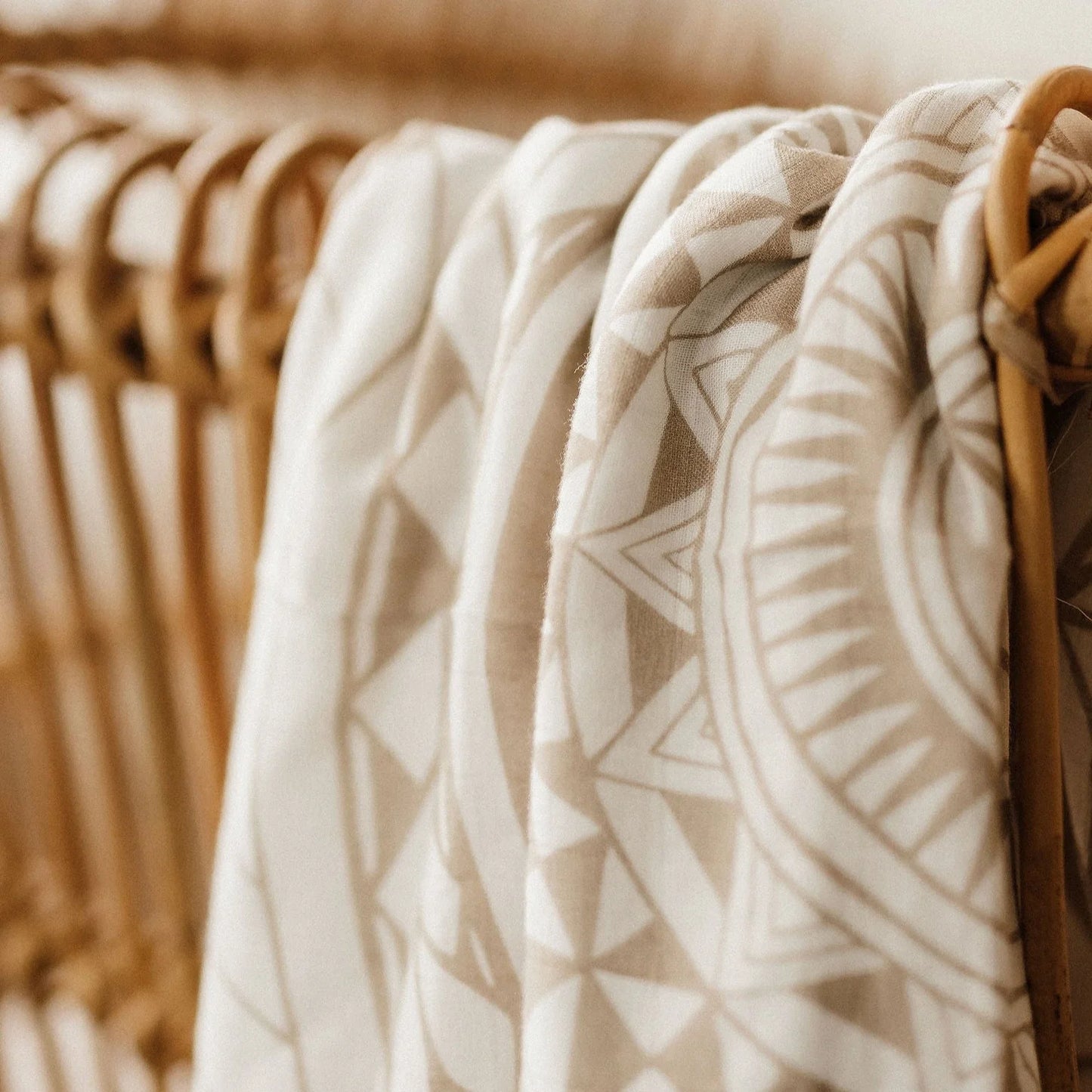Beige patterned fabric draped over a wicker chair
