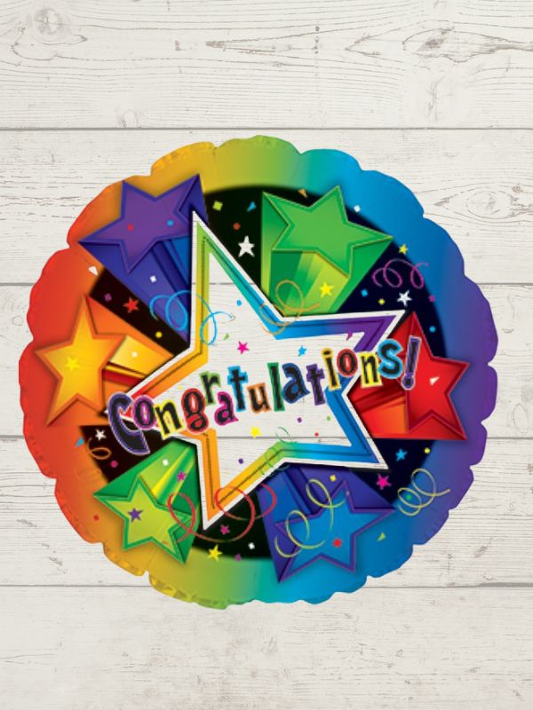 A round, multicolored balloon with the word 'CONGRATULATIONS' and star decorations on a wooden background.