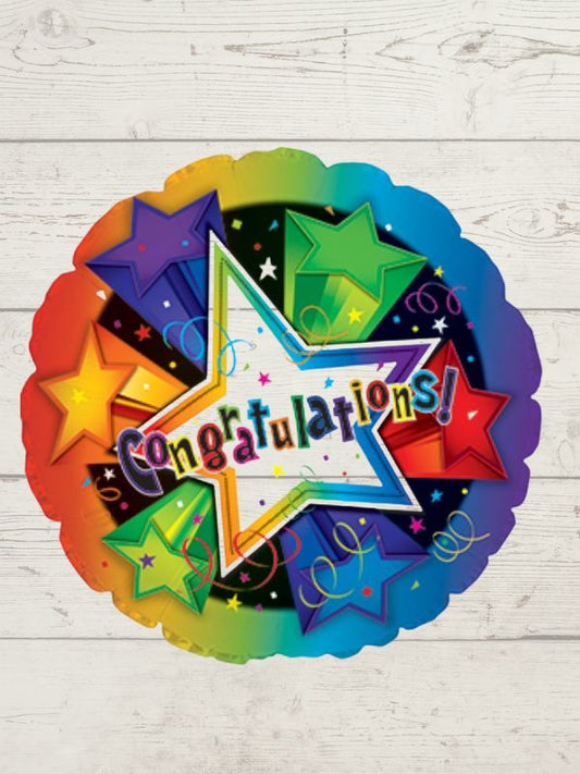 A round, multicolored balloon with the word 'CONGRATULATIONS' and star decorations on a wooden background.