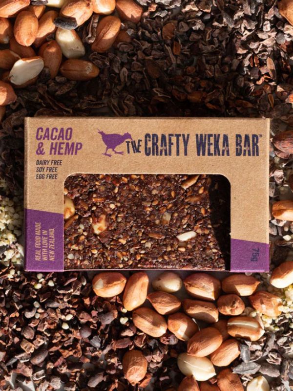The Crafty Weka Bar packaging for a cacao and hemp bar surrounded by nuts and seeds.