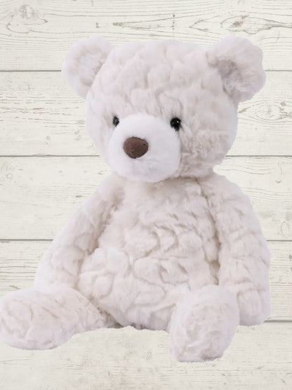 white bear sitting on a wooden surface