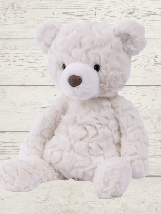 white bear sitting on a wooden surface