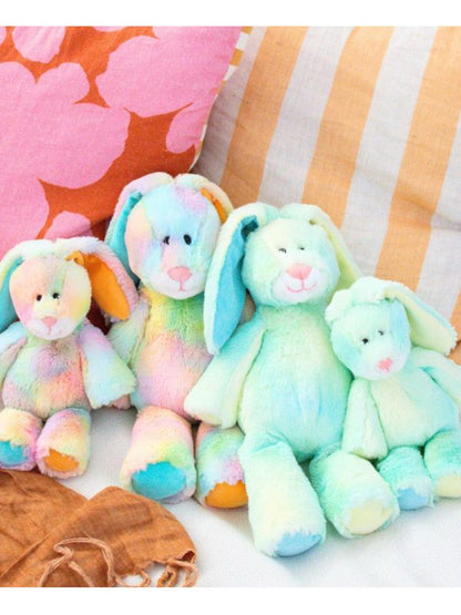 Colorful plush bunnies on a striped fabric background