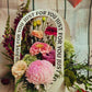 flowers in pinks and reds displayed in container with handle. Handle has the words just for you on it. 