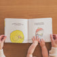 children's book with bright pictures, hands and on a wooden surfaace