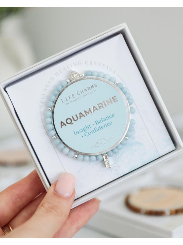Aquamarine bracelet in a box held by a hand