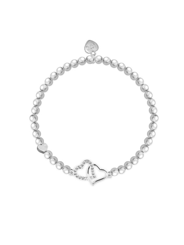 Pearl bracelet with silver heart charms on a white background