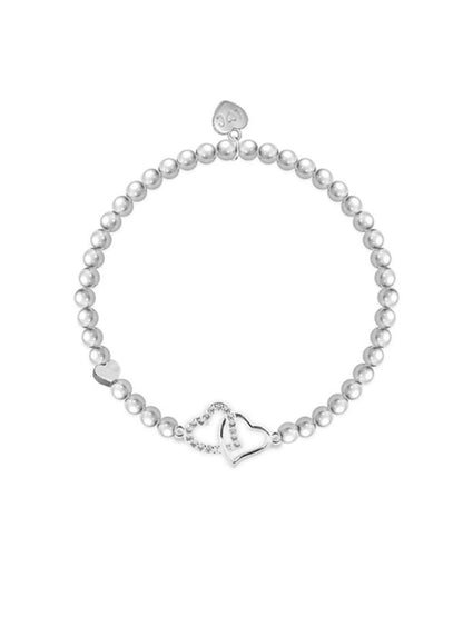 Pearl bracelet with silver heart charms on a white background