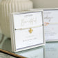 Bracelet with bee charm on a branded card
