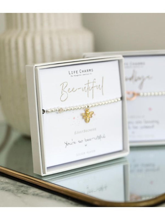 Bracelet with bee charm on a branded card