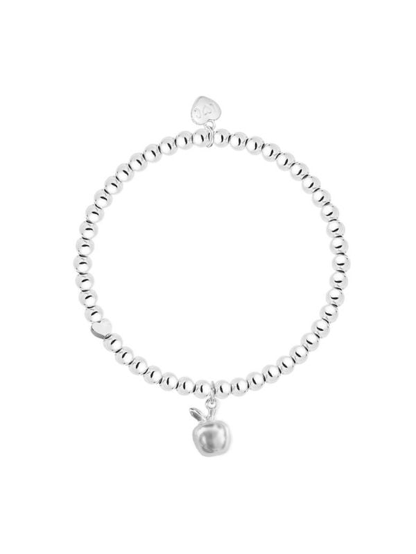 Silver bracelet with a small apple charm on a white background