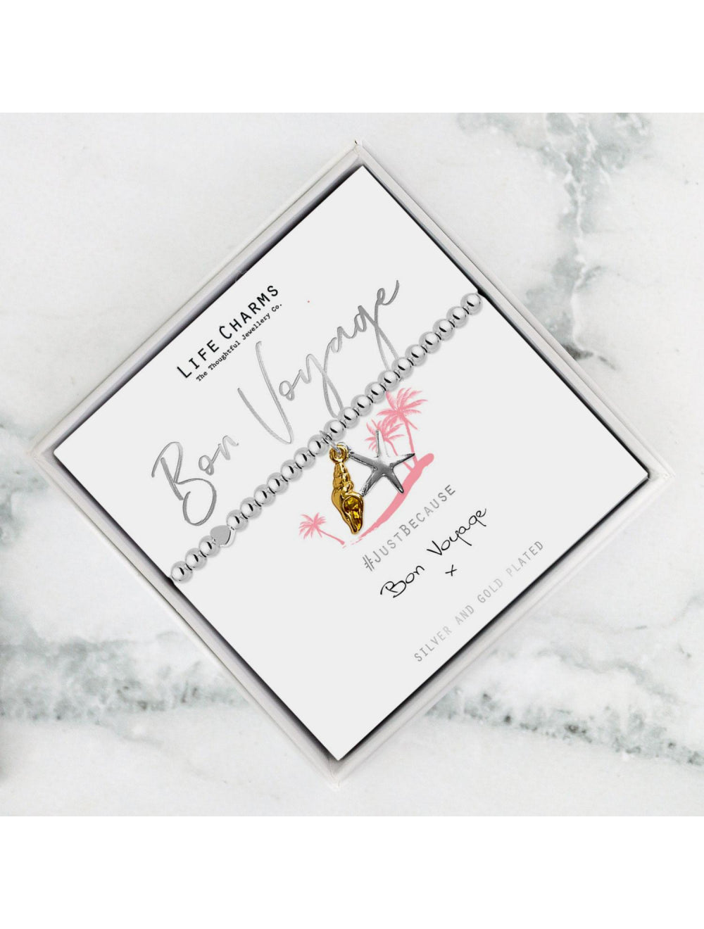 Jewelry box with 'Life Charms' branding on a marble surface