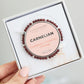 Life Charms Carnelian bracelet in a box held by a hand