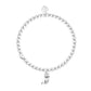 Silver bracelet with a small charm on a white background