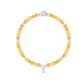 Yellow beaded bracelet with silver heart clasp on a white background