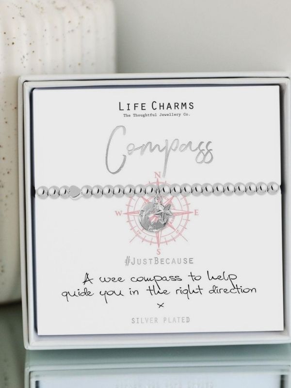 Life Charms compass bracelet packaging with text on a white background