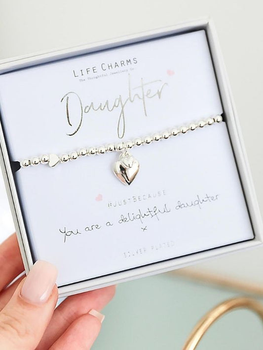 Gold bracelet with heart charm on a 'Daughter' card in a box