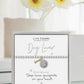 Life Charms dog lover bracelet on a card with flowers in the background