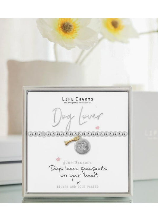Life Charms dog lover bracelet on a card with flowers in the background
