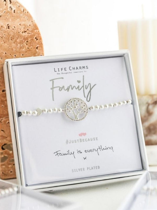 Silver bracelet with tree design on a 'Life Charms' card with 'Family' text.