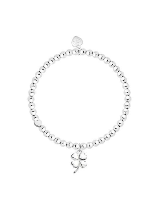 Silver bracelet with a clover charm on a white background