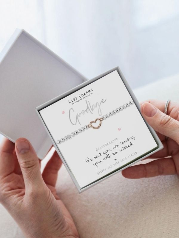 Bracelet with 'Goodbye' message in a box held by hands