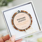 Bracelet with 'Picture Jasper' description in a white box held by a hand.