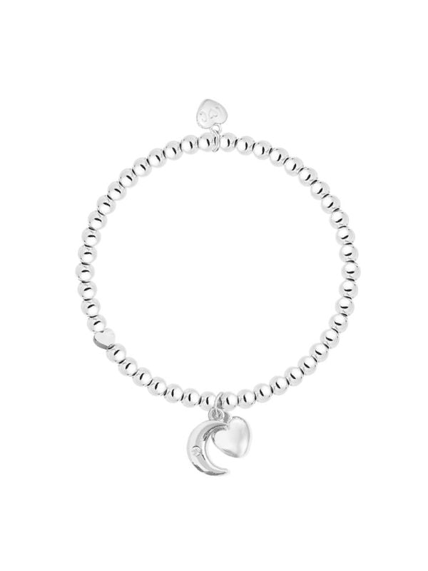Silver bracelet with a moon charm on a white background