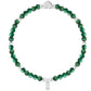 Green beaded bracelet with silver clasp on a white background