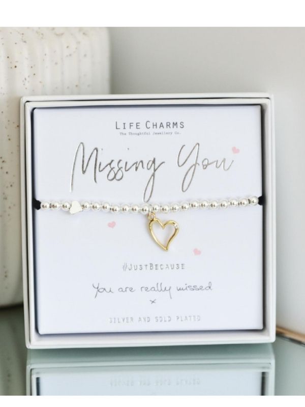 Bracelet with heart charm on a card labeled 'Missing You' by Life Charms.