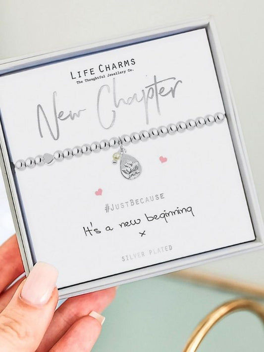 Person holding a pink plush toy with a neutral background