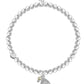 Pearl bracelet with a silver charm on a white background