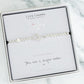 Silver bracelet with 'Sister' charm on a Life Charms branded card with marble background
