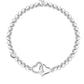Pearl bracelet with silver heart charms on a white background
