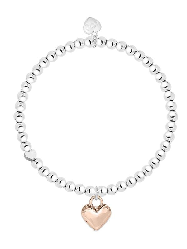Silver beaded bracelet with a rose gold heart charm on a white background